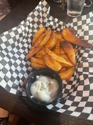 Half order of the potato wedges with a side of truffle aioli.