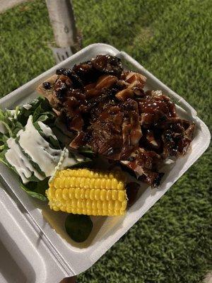 BBQ chicken in a bed of rice, spinach & corn on cob