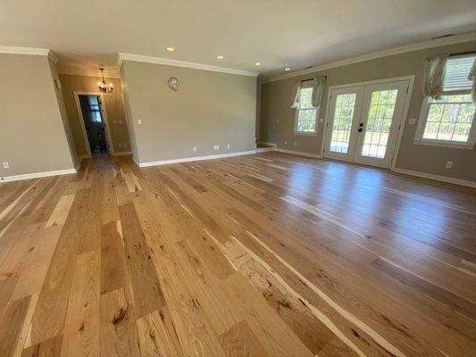 Living room, 8" hickory planks, some of them up to 12' long! Tough work to get them lined up and flat, but they're amazing.