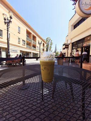 Iced matcha almond milk large and in charge. Plastic cup and metal table and business signage. :^'0. Just kidding. Lol