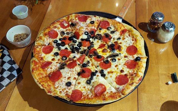 Pepperoni, mushroom and black olive pizza