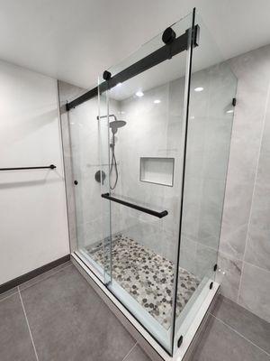 90° frameless sliding glass shower door with towel bar