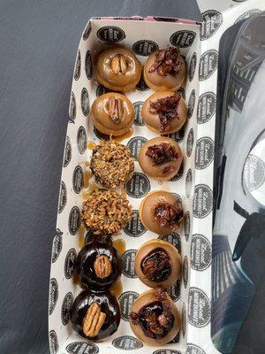 12 Pieces Mini Donuts with four maple bacon donuts on the upper right which is their #1 seller