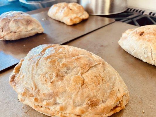 Pasties: Ham & Cheese, Cousin Jacks & Pulled Pork.   Cousin Jacks: Traditional Cornish Recipe. Skirt steak, potatoes, onions, and parsley.