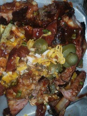 Loaded baked potatoes with sausage and ribs