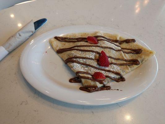 Nutella Crepe topped with strawberries and powdered sugar