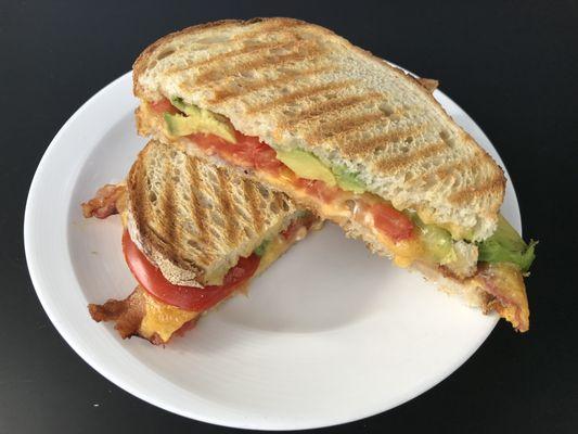 Bacon, avocado, tomato & cheddar panini