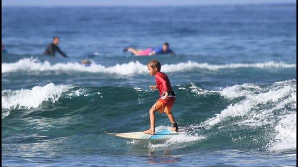 6year old Kahakai surfing the home break out front!