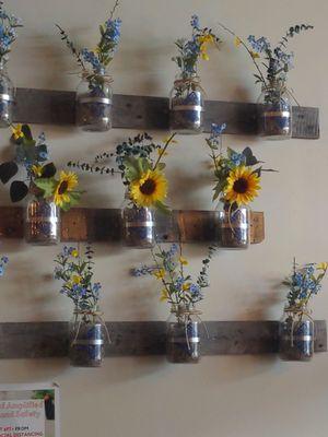 Flowers on the wall in mason jars. Very cool design