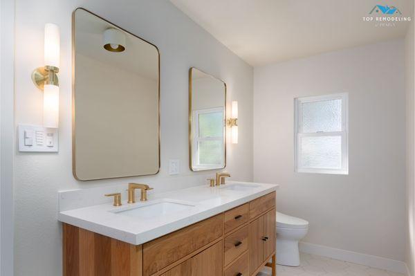 This elegant bathroom remodel by Top Remodeling & Design features a spacious shower and beautiful tile work. #general #contractor