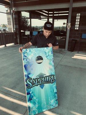 Clay was showing us the custom corn hole boards they have. (They also have tournaments!)