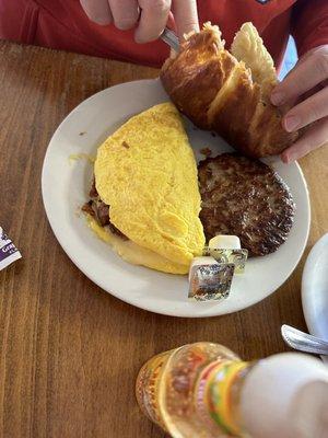 Omelette, side of sausage and a Croissant