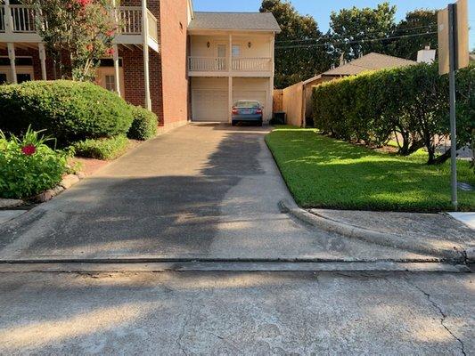 Trimmed Hedges, mowed front lawn and edging the perimeter, and a blowed hardscape.