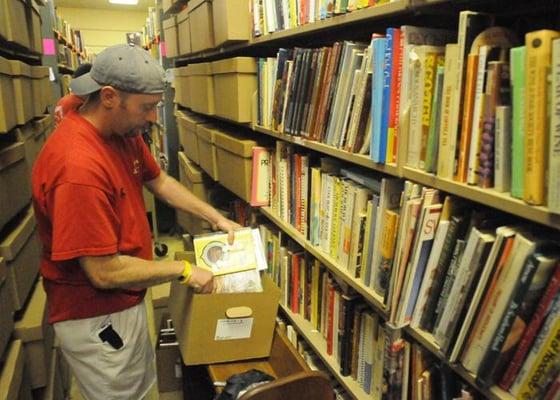 a customer in the stacks of The Title Page (photo: Pete Bannan for The Main Line Times)