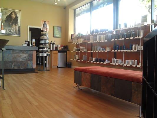 Waiting area with many Aveda products for sale.