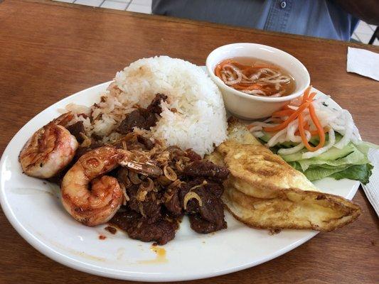 Combination grilled beef and shrimp with accompaniments of fried egg and pickled veggies!