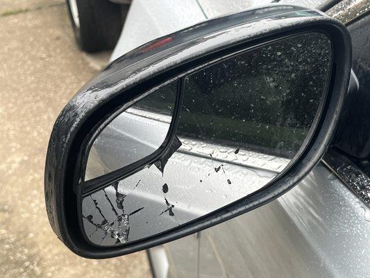 The sideview mirror that was not repaired.