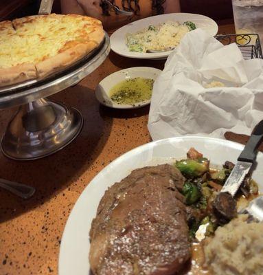 House Salad, Fettucine Alfredo With Broccoli, Primrib with mashed potatoes, and white pizza.