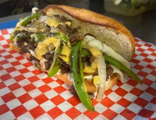 Sarah's Steak Sammie with peppers and onions topped with provolone and Beer cheese and mayo. Make it a combo with fries.