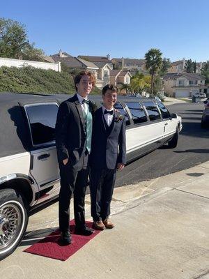 My son and his friend in front of the limo