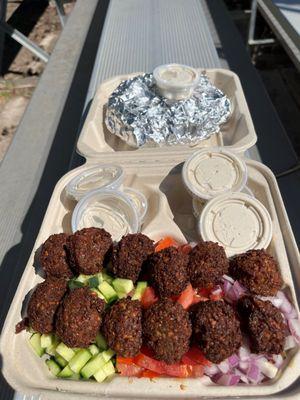 What I got . . . a huge falafel plate with generous sides of tomatoes, onions and cucumber.