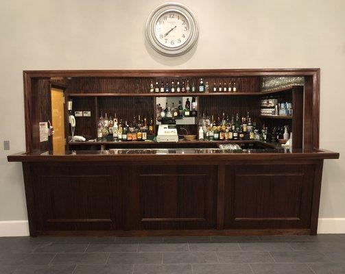 Fully stocked bar, with bartender