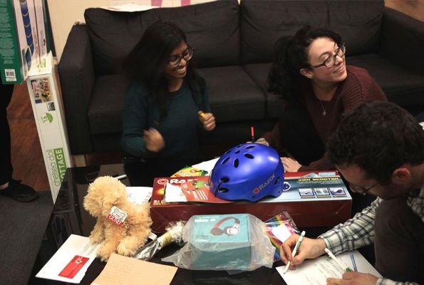 Team members wrapping up gifts for charity.