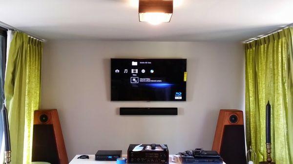 Home media center, flat screen and surround sound mounted with wire concealment 9.1 surround sound system, custom installation.