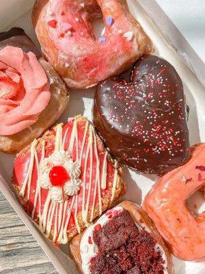 Valentines Day flight (neapolitan, vanilla glaze, white chocolate cherry, double chocolate filled, red velvet, and cardamom rose)