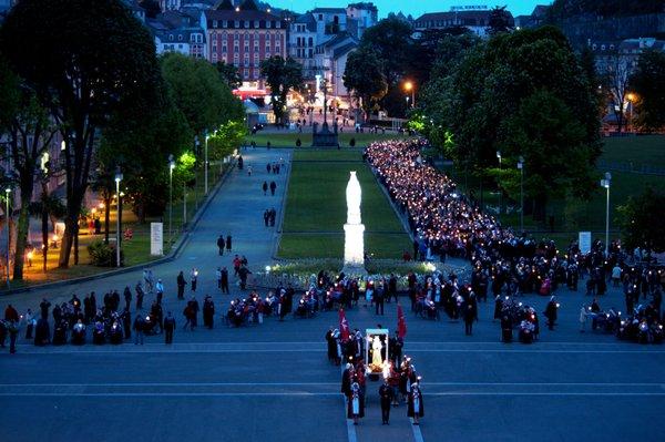 Pilgrims join together in the Torchlight Procession in Lourdes, France.