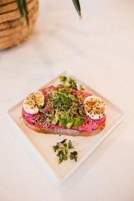 Avocado beet hummus toast with organic local egg