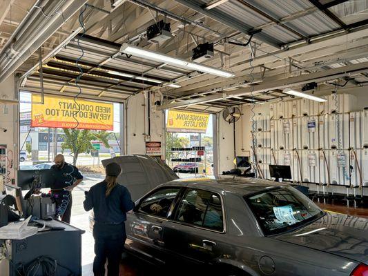 Technicians servicing a car at Take 5 Oil in Riverdale, UT