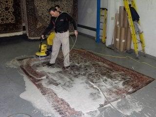 Phil Ziegler washing and rinsing an Oriental rug with his Plant manager Tom Straub. All washing is done at their danbury plant.