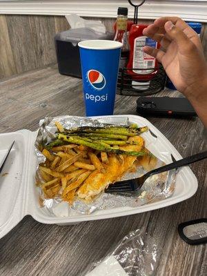 Fried flounder with asparagus and fries.