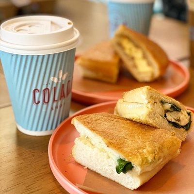 Egg and spinach breakfast sandwich and cafe con leche