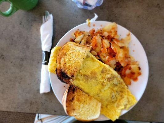 This is a 3 egg Irish omelet, homemade corned beef, sourdough and potatoes.