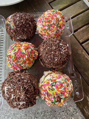 Half a dozen ice cream cupcakes (cookie on the bottom) chocolate and vanilla ice cream with jimmies and rainbow