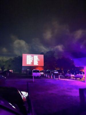 Movie Screen in front and food shack to the right