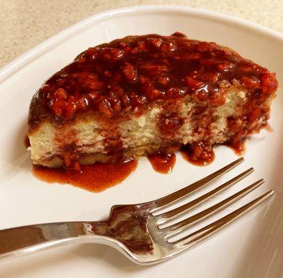 Half of the Strawberry Basil Balsamic Cheesecake, fork shown for scale. I added diced strawberries to the sauce that comes with it.