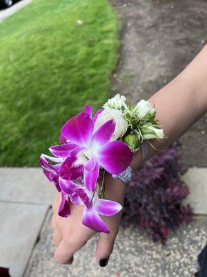 Beautiful Prom Corsage with the purple & white flower (closest to my daughter's hand) by Modesto Exotic Flowers.