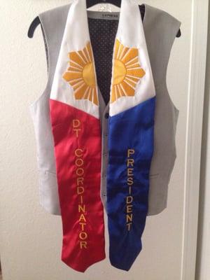 My graduation stole embroidered with "DT Coordinator" and "President".