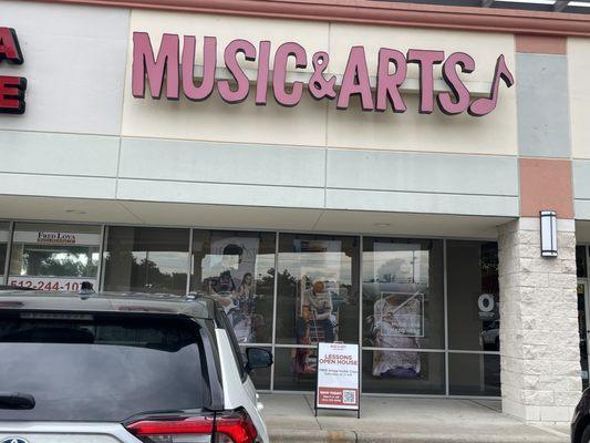 Front of store.  Free guitar classes on Saturday !!