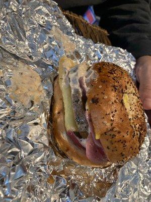 Steak breakfast sandwich with pickled onions on an everything bagel