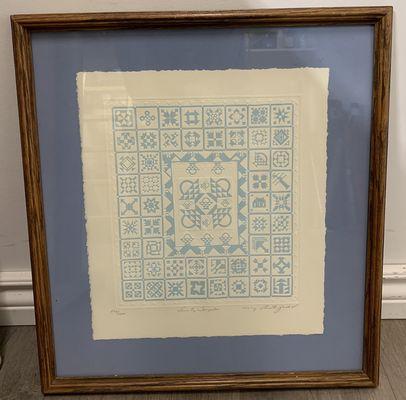 light blue textile piece with a blue matting and gold frame. so original!