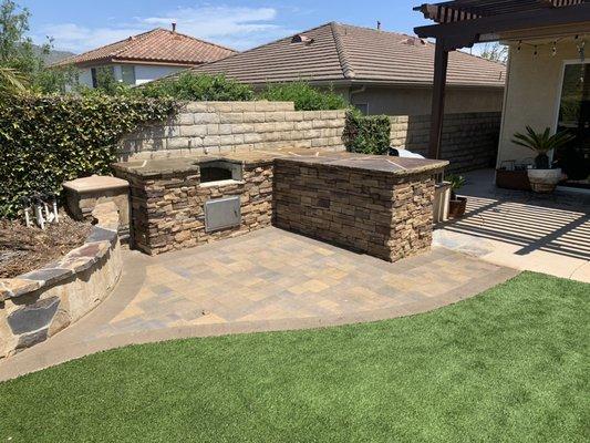 Bbq island, turf, stacked stone, pavers, stone countertop