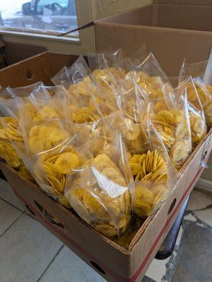 Fried plantain chips packaged and ready to be sealed