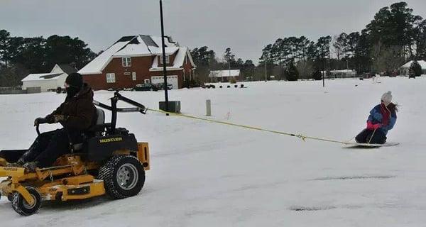 Hustler mower working in the snow.