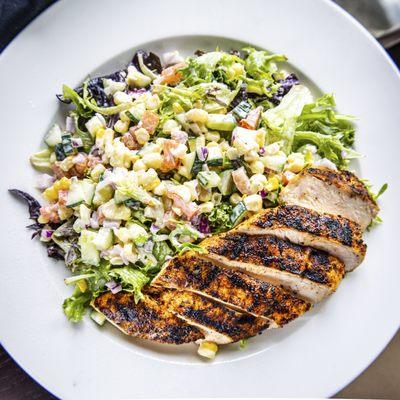 BLACKENED CHICKEN SALAD: 
blackened chicken, roasted corn, cucmber, diced tomato with buttermilk dressing