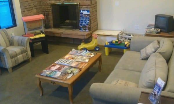 waiting room with tv, magazines, comfy seats, toys for kids, free book exchange