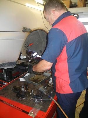 Dave Leprau-Kaan repairing a vehicle and saving a customer GREEN just in time for St. Patrick's Day!